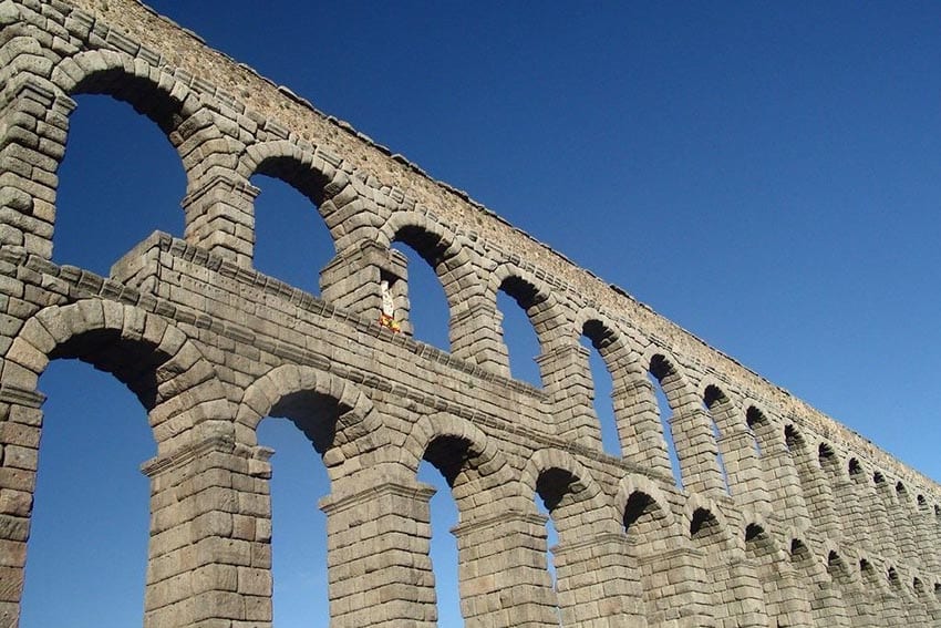 The double arches of the Segovia Aqueduct taken against a blue sky