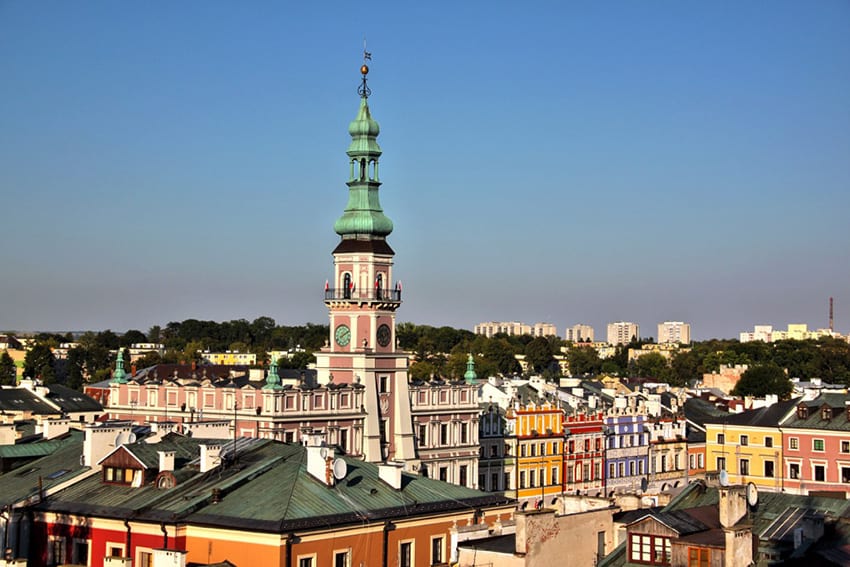 Old town in Zamosc showing roofs of buildings and spire of a church