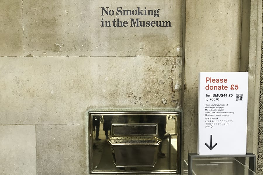 Text on stone wall saying No Smoking in the Museum