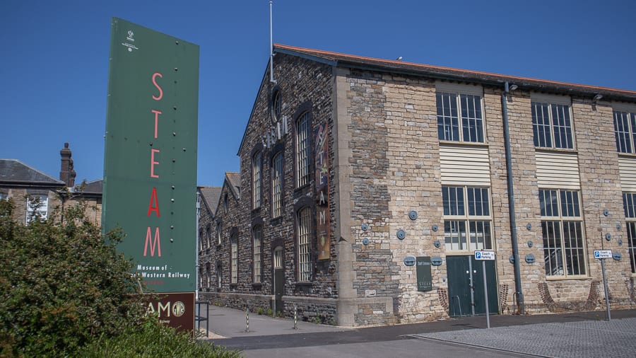 building with green window frames and a banner saying The STEAM Museum