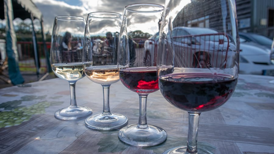 Four glasses of wine, from left, white, rosé, and two reds 