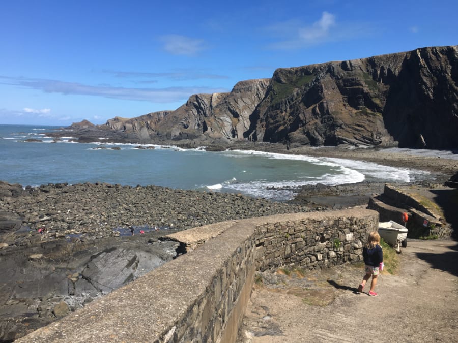 Hartland Quay with a rocky beach and cliff behind