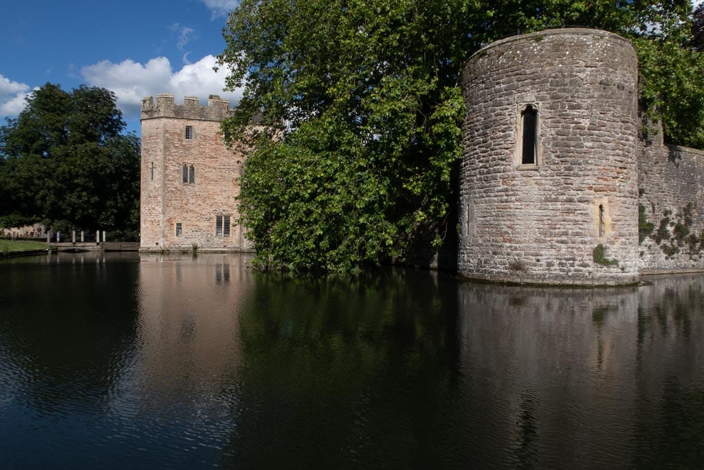 stone built Bishops Palace on a moat with trees in the middle