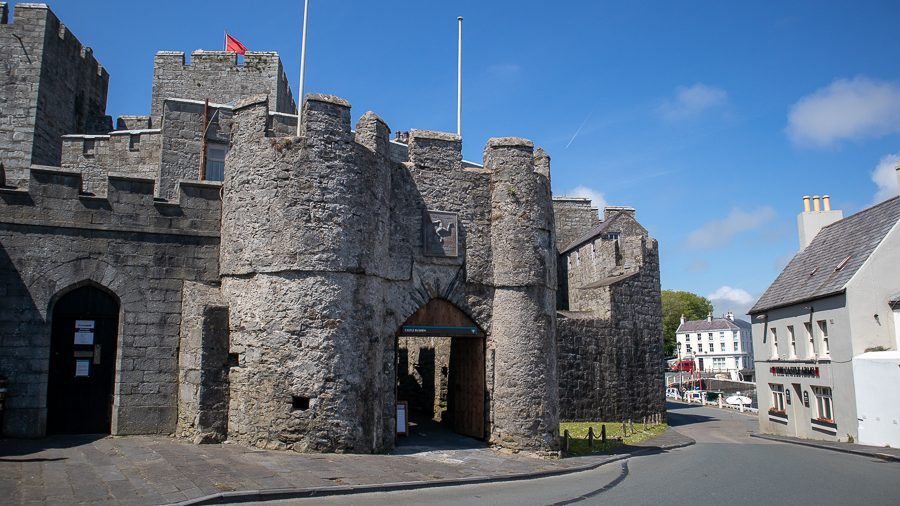 arched entrance to the 13th Century Castle Rushen with crenelations on the walls
