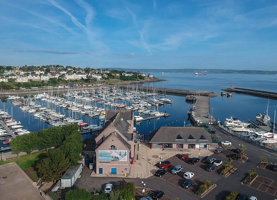 aerial view of Bangor harbour with lines of yachts and a town in the background