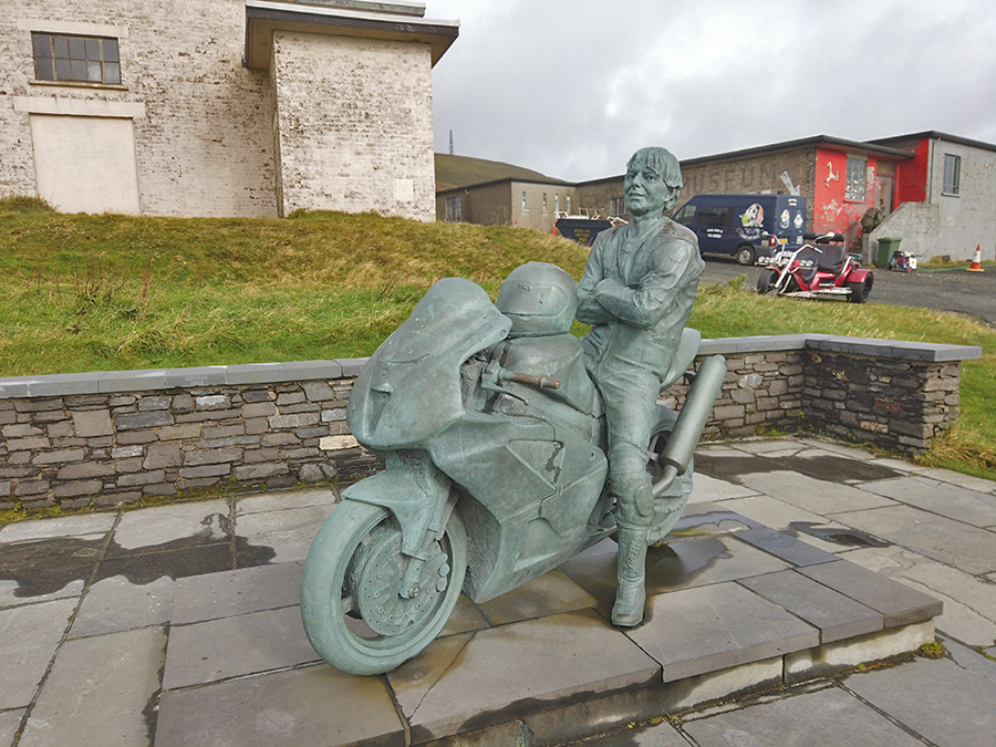 sculpture of a man called Joey Dunlop on a motorbike