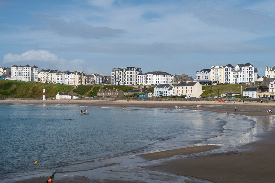 beach with the sea coming in and tall white guest houses behind
