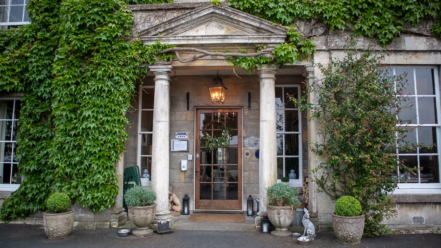 pillared entrance to the Burleigh Court Hotel with ivy to the left and above