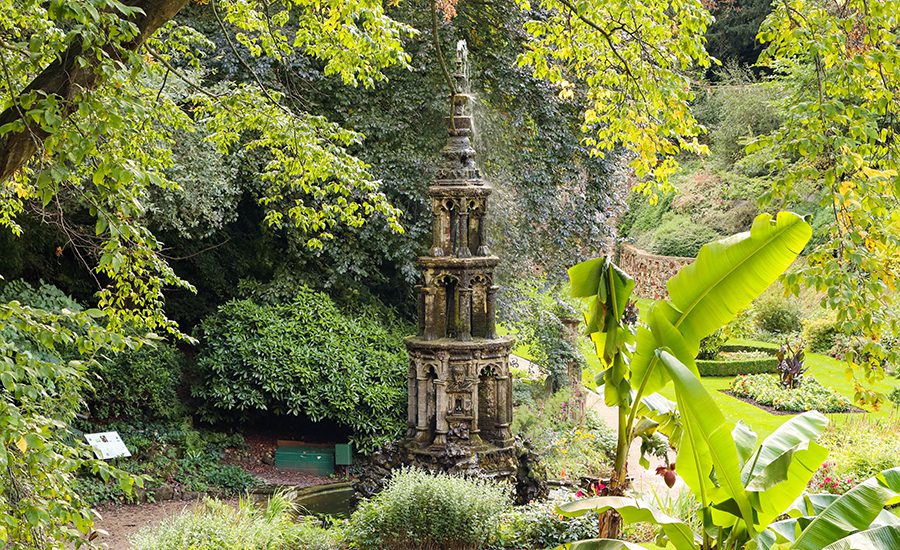 Ornate tower in Plantation Garden in Norwich with banana trees in the foregroun