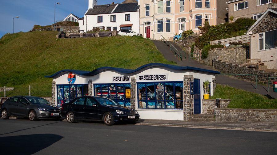 One of the best things to do in Port Erin is to go Paddleboarding. Port Erin Paddleboarders has a blue wave roof and large windows.