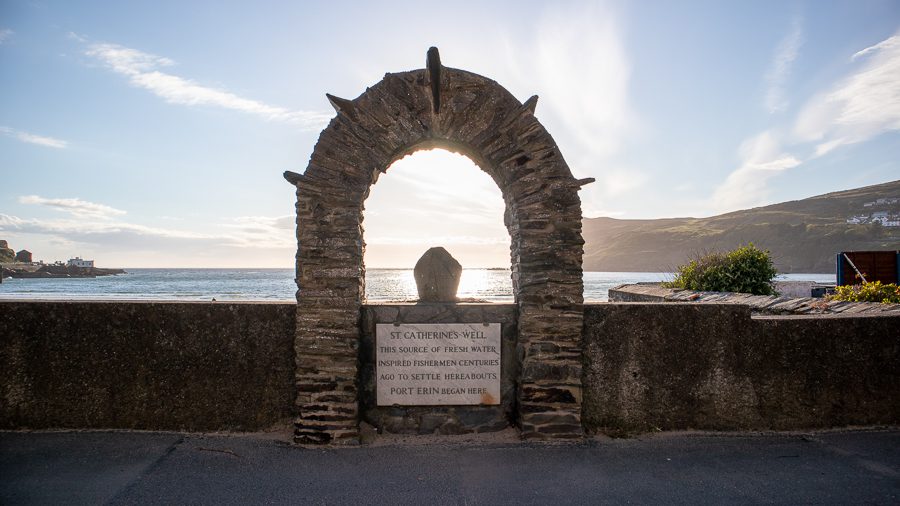 Arch above sign which says "St Catherine's Well, the source of fresh water inspired fishermen centuries ago to settle hereabouts. Port Erin Began Here," one of the things to do in Port Erin