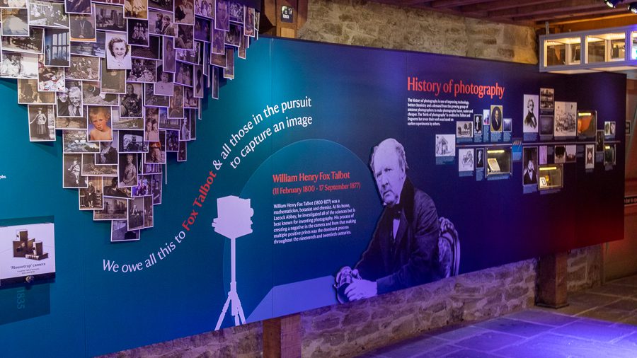 Fox Talbot Museum in Lacock - teal long board with History of photography on it and a picture of William Henry Fox Talbot