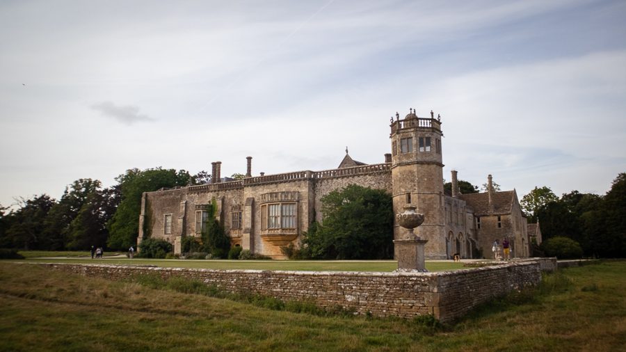 Lacock Abbey seen from one corner with a hexagonal tower and large bay window