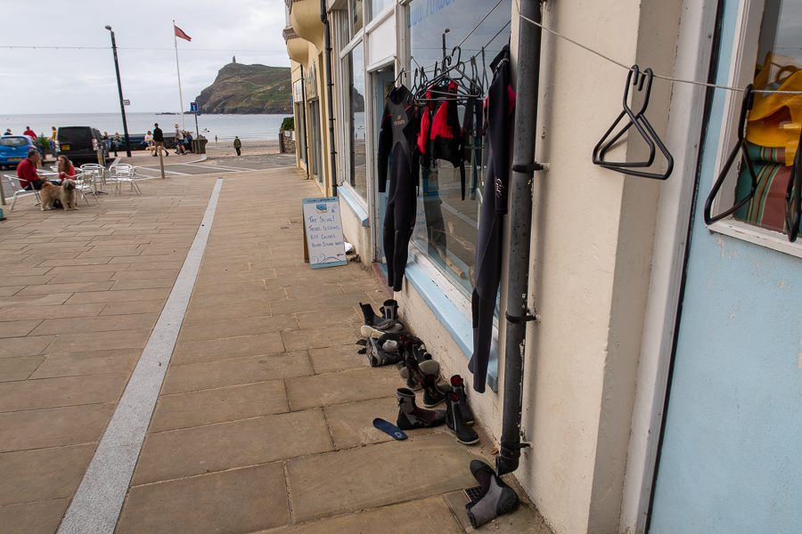 The outside of 7th Wave in Port Erin with Wetsuits hanging up