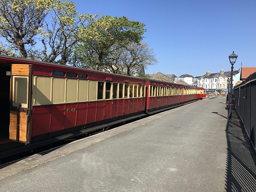 Steam train in Port Erin Isle of man with red and cream carriages