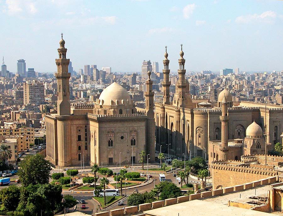 The old mosque in Cairo with the modern city behind