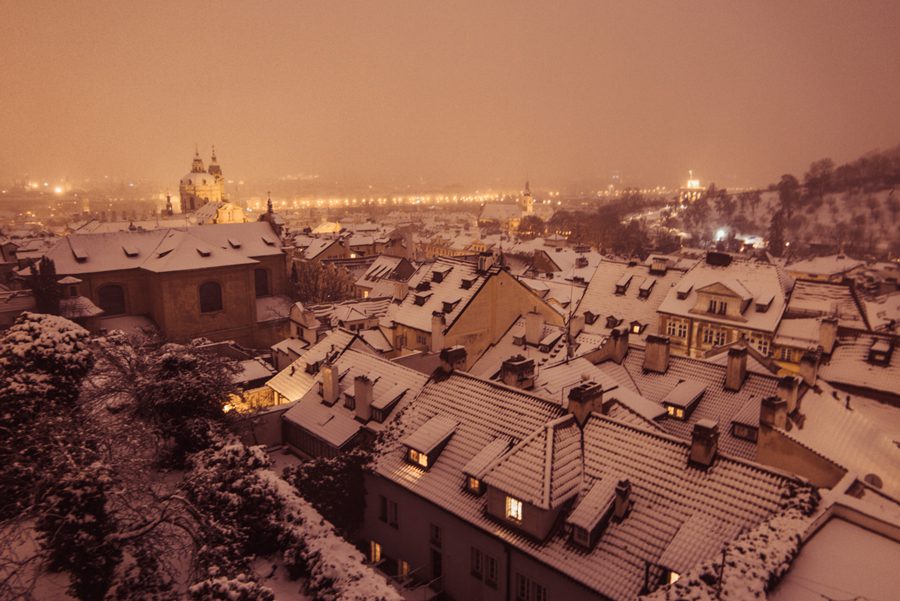 snow-topped houses in dusk in Prague