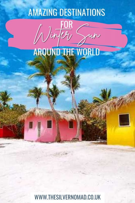 brightly coloured beach shacks with palm trees and Amazing Destinations for Winter Sun around the World written on top