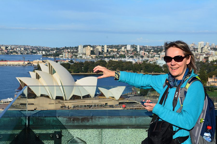 Michaela from Rocky Travel Blog in Sydney trying to hold the Sydney Opera House