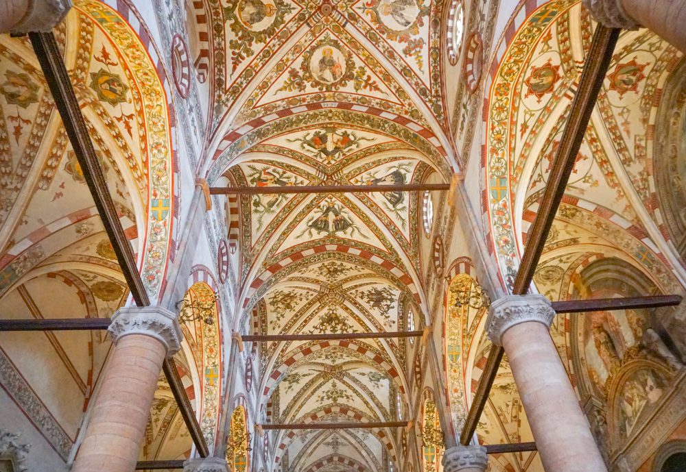 the ornate ceiling of Verona church with highly decorates arches above the columns