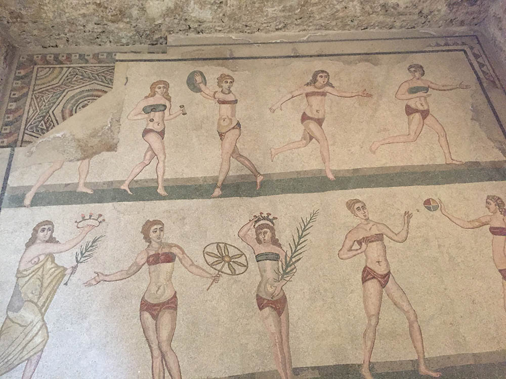 mosaics showing tow rows of ladies in red or green tops and red bottoms doing sports