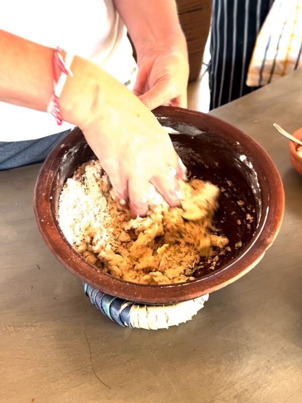 Mixing the roti dough in clay bowl