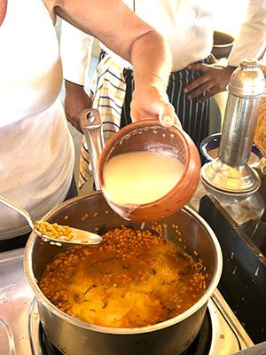 pouring the coconut milk into the dhal