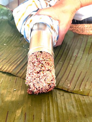 the pittu being squeezed out of the pittu steamer