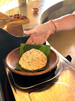 the finished roti placed on a banana leaf on a clay plate