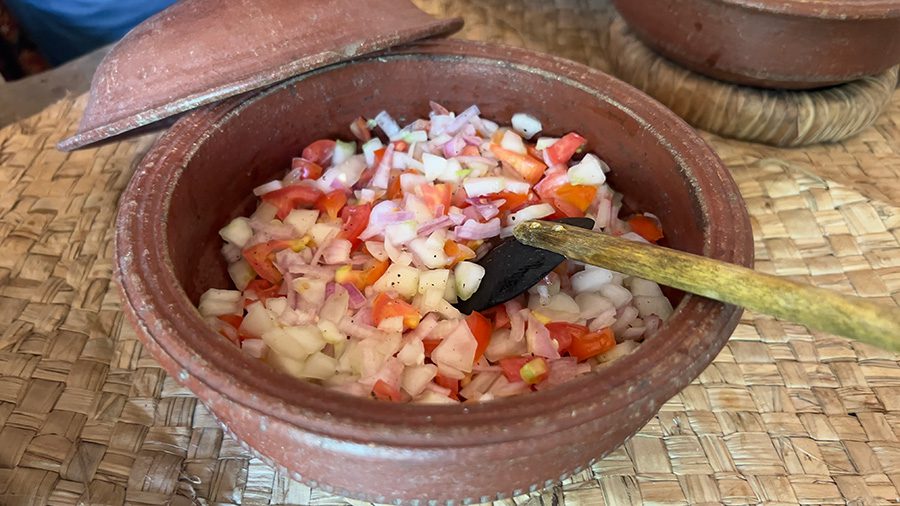 onion, cucumber and tomato sambal in a clay lidded pot