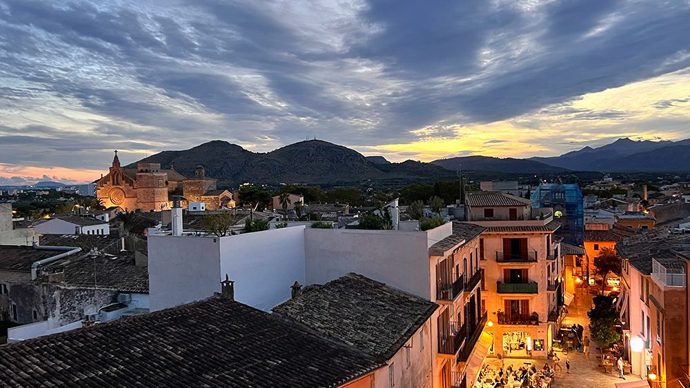 View of Alcudia Old Town from the roof top with sunset lighting the sky