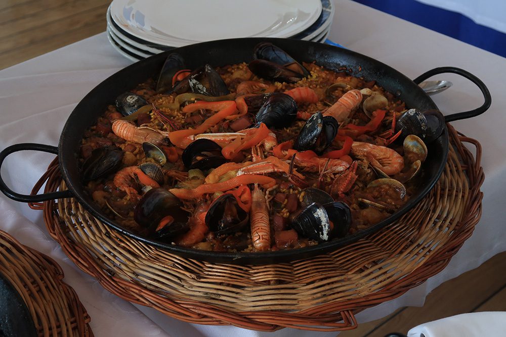 Dish of paella with prawns, museels, peppers and rice