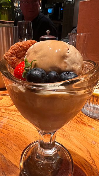 Supper in the Travelling Duke with a glass stemmed dish of ice cream with strawberries and blueberries