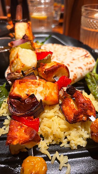 Supper in the Travelling Duke with vegetable and halloumi kebab with pitta bread on a bed of yellow rice