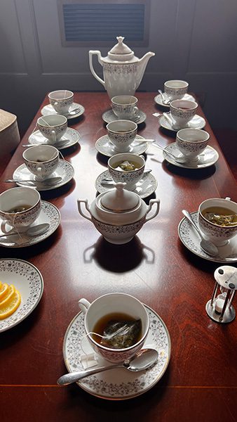 china tea pot with cups and saucers ready for tea tasting