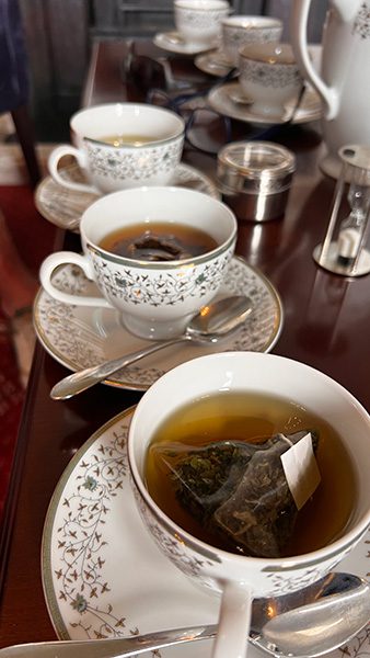 Tea tasting with three cups and saucers