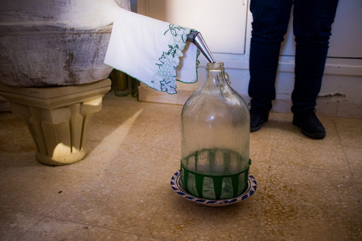The condensed floral water drips into the water bottle