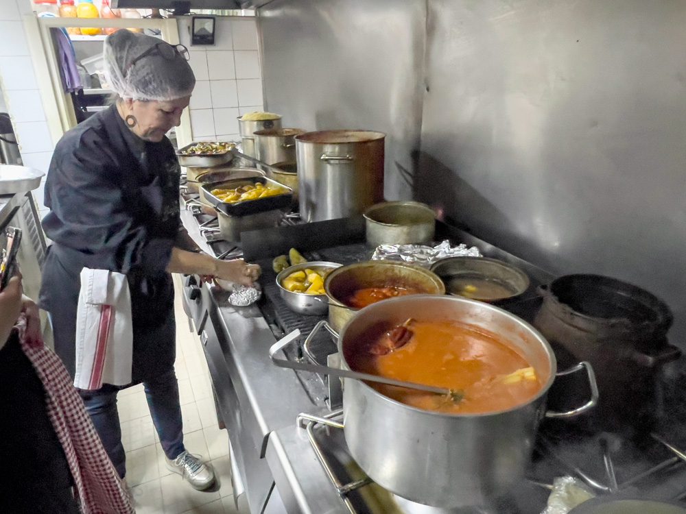 Sofie at Dar Sala showing how to prepare Salata machouia in front of the cookers
