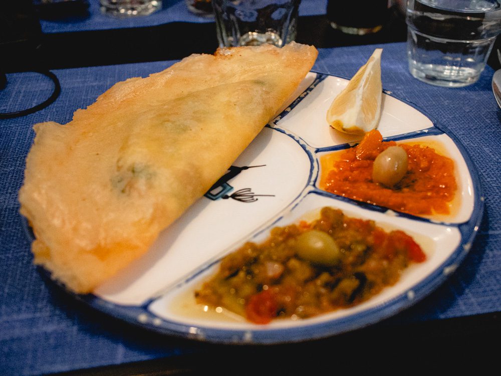 Brik with omek houria and machouia on a white and blue plate