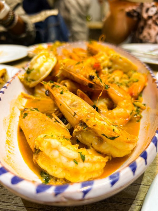 Grilled prawns on white and blue plate