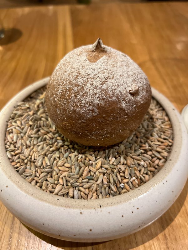 round ball of rye bread on a dish raw rye
