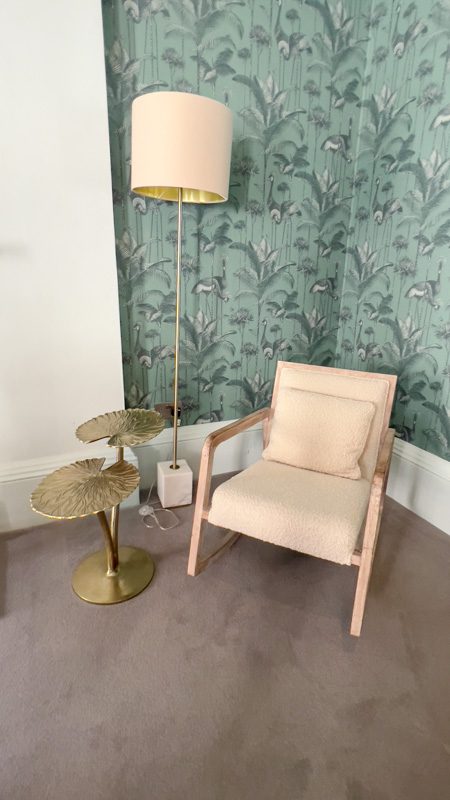 cream armchair with standard lamp and gold leaf shaped table