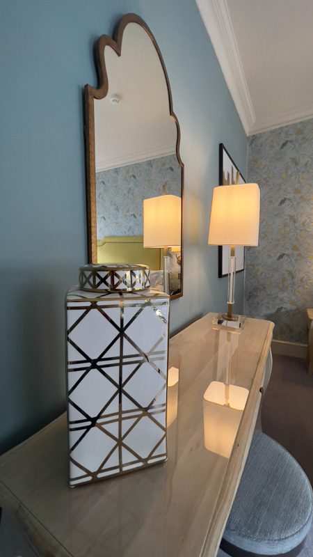 dressing table with white and gold ginger jar on it