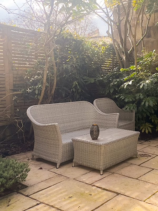 wicker sofa in the garden of the Queensberry Hotel