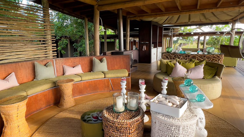 semi-circular seating area with green and pink cushions