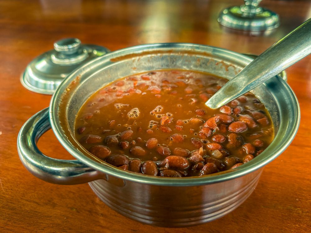 Bean Stew in a silver metal dish with spoon