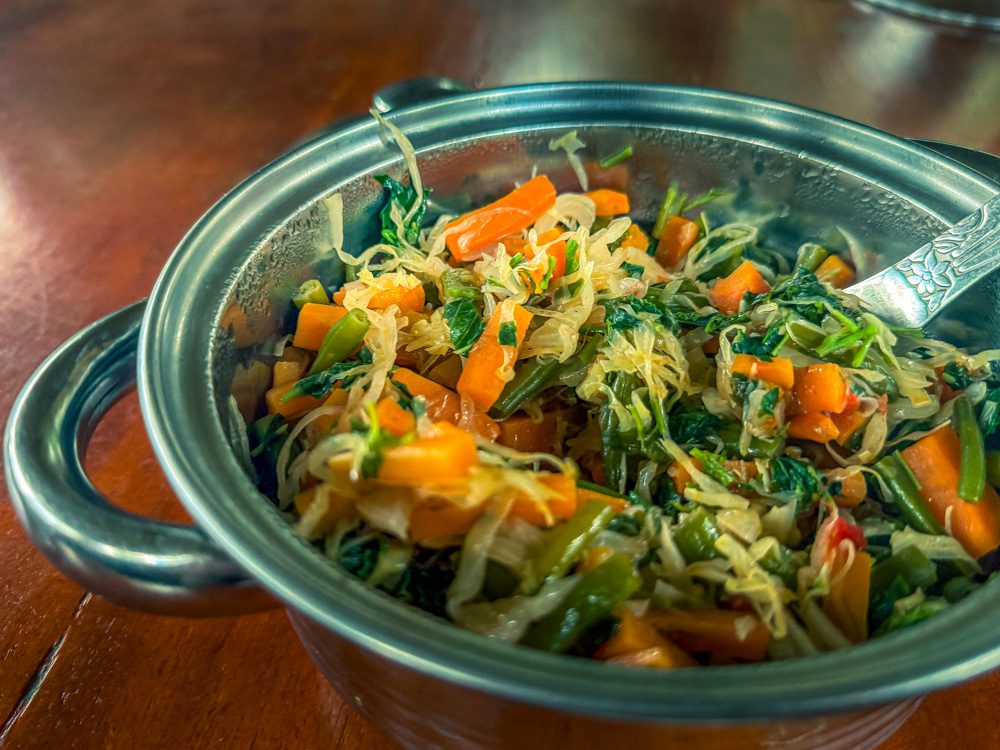 Vegetable Stew in a silver metal dish with spoon
